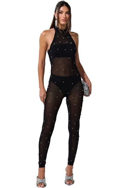 Woman wearing a black outfit with rhinestone embellishments on a white background