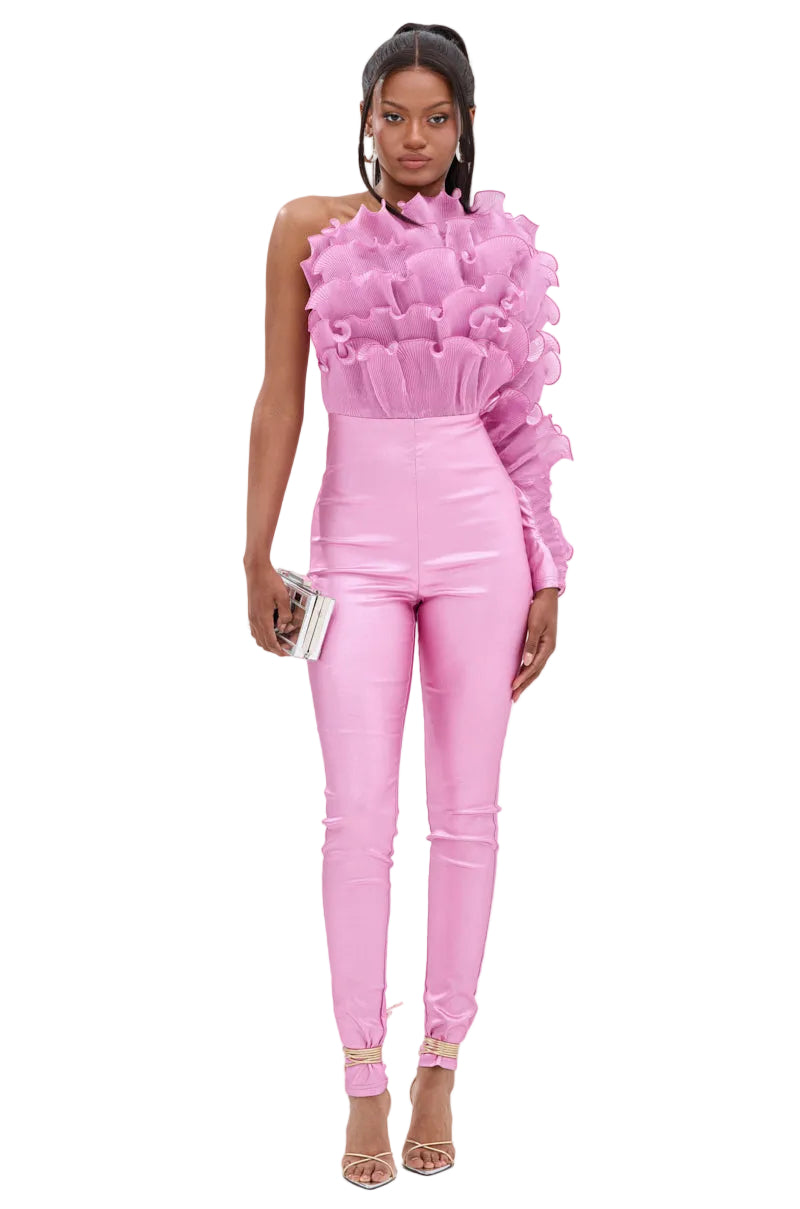 Woman wearing a pink ruffled top and pants on a white background