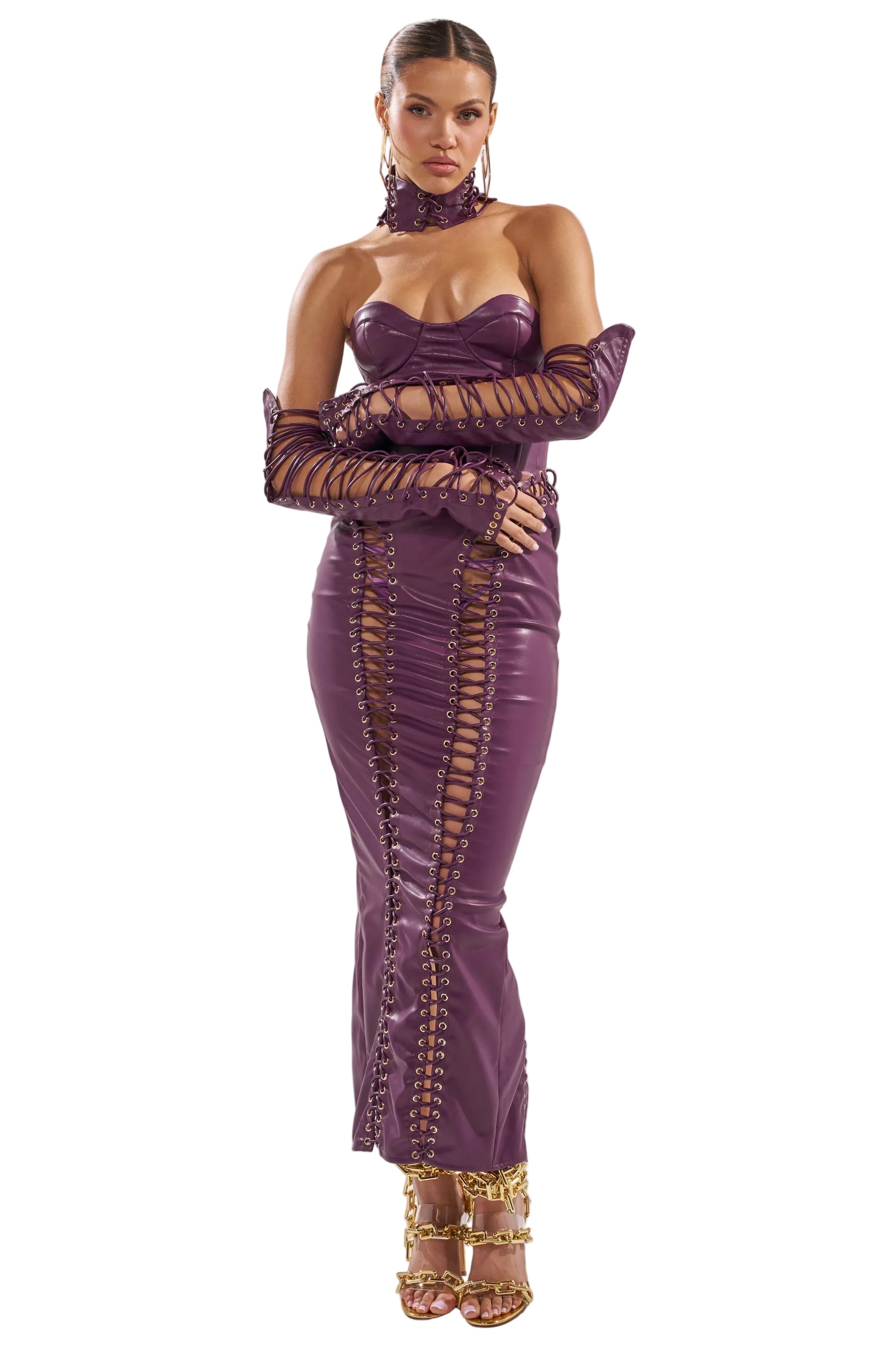 Woman wearing a purple outfit with gold accents on a white background