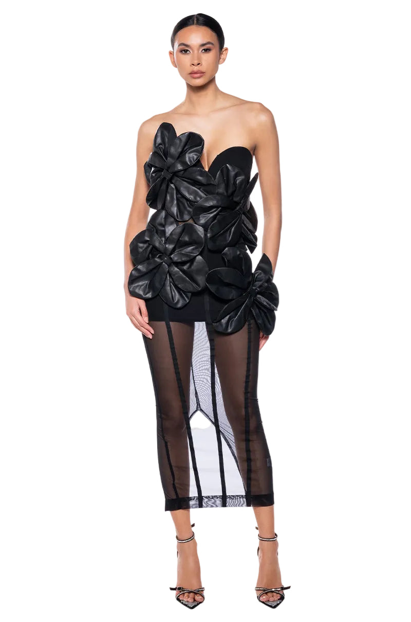 Black strapless dress with floral details on a white background