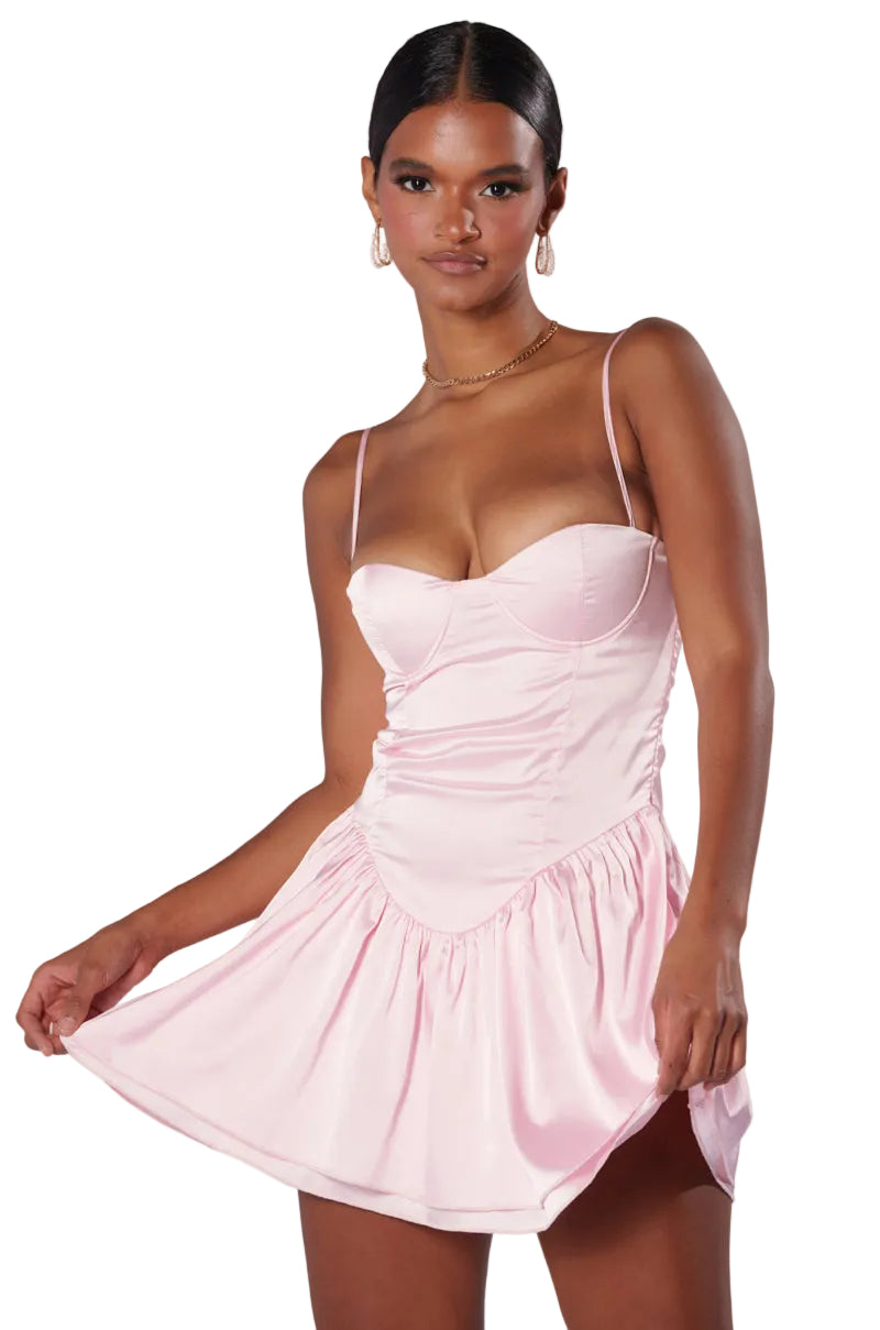 Woman wearing a pink dress against a white background